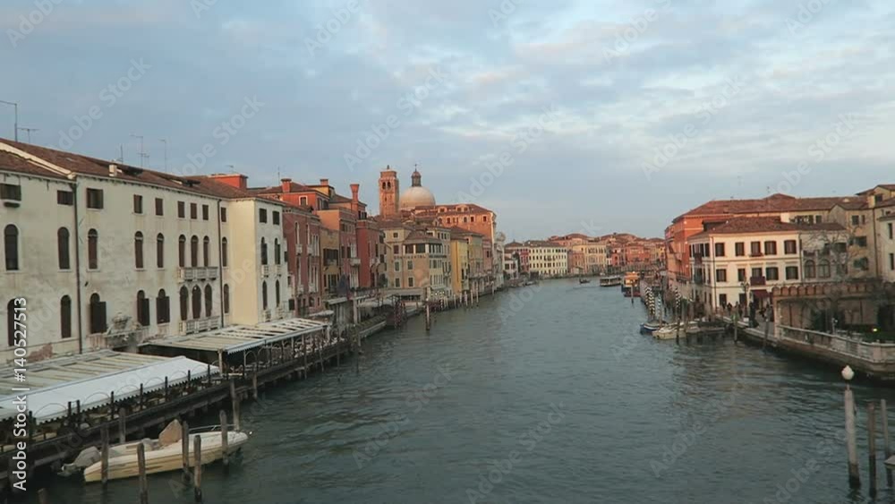 Venice, Italy Grand Canal view with historic buildings and mooring piles. Evening view from Ponte dei Scaltzi – Bridge of the barefoot. Venice, Italy Grand Canal view with historic buildings and mooring piles. Evening view from Ponte dei Scaltzi – Bridge of the barefoot.