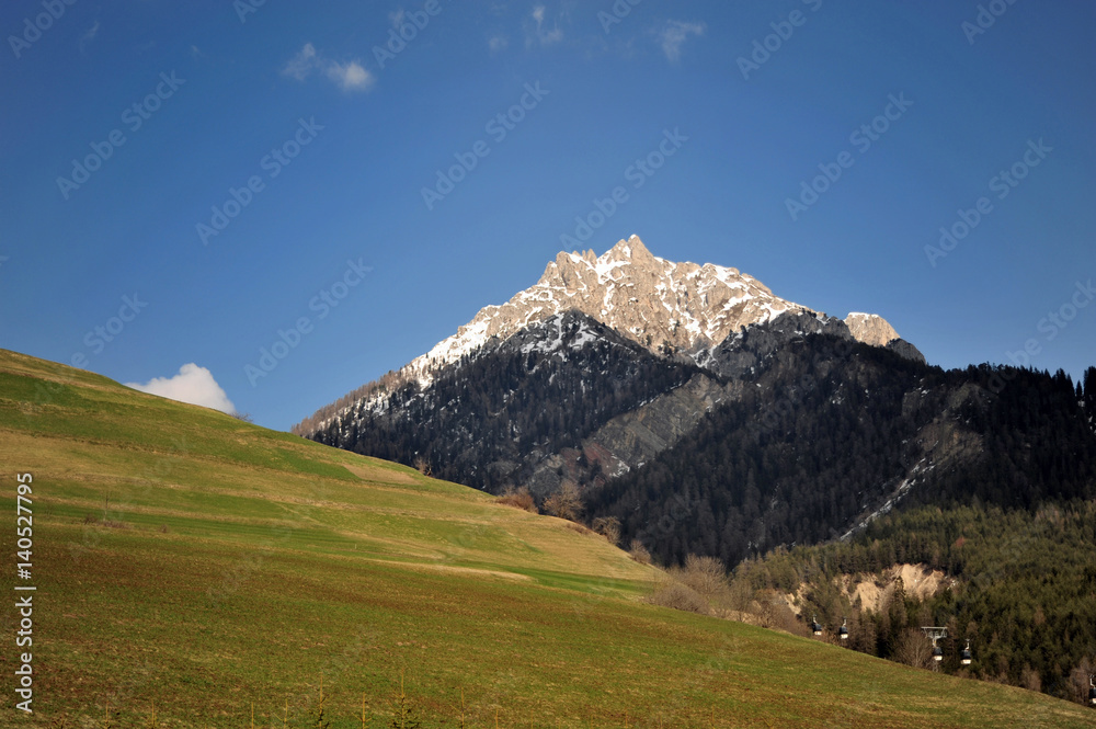 Landscape of Dolomites mountains in summer with meadows and mountains