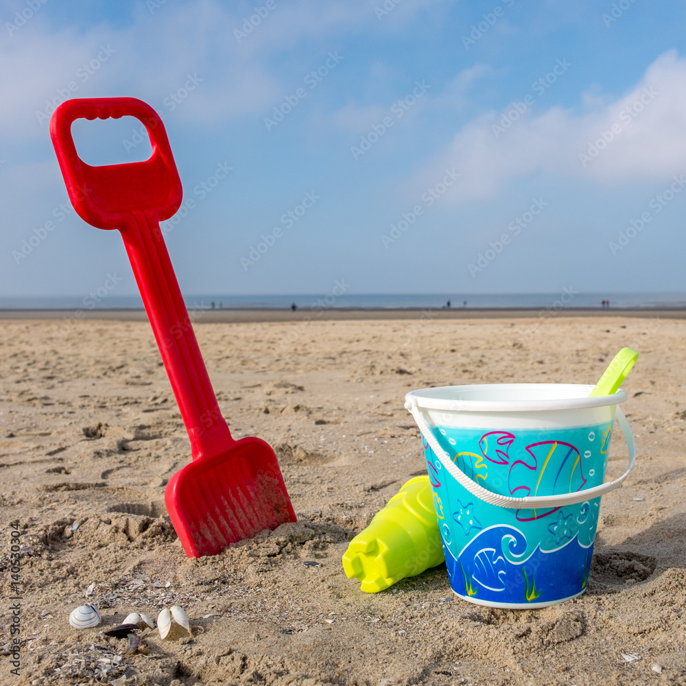 Children's bucket and spade on the beach of De Haan, Belgium. Children's bucket and spade on the beach of De Haan, Belgium.