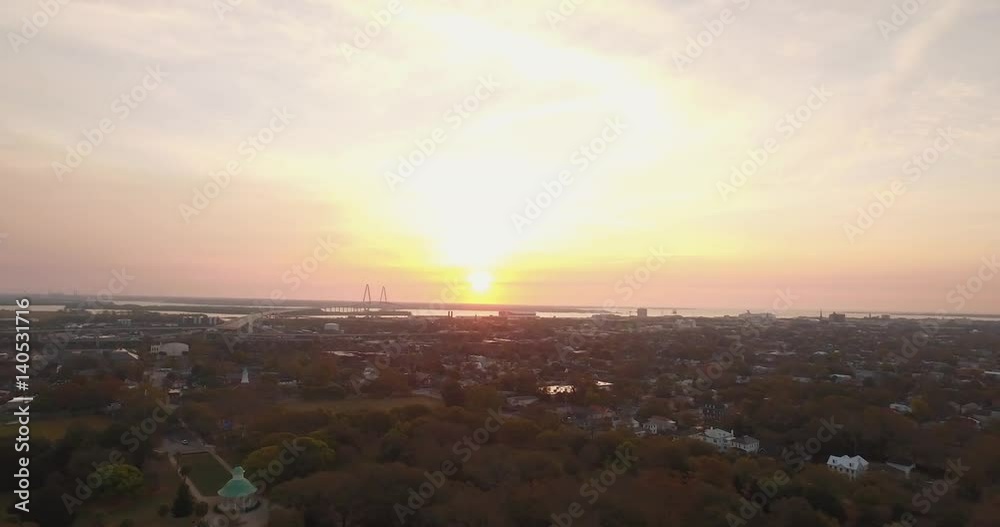 Aerial of downtown Charleston at sunrise with Ravanel Bridge visible in the landscape. Aerial of downtown Charleston at sunrise with Ravanel Bridge visible in the landscape.