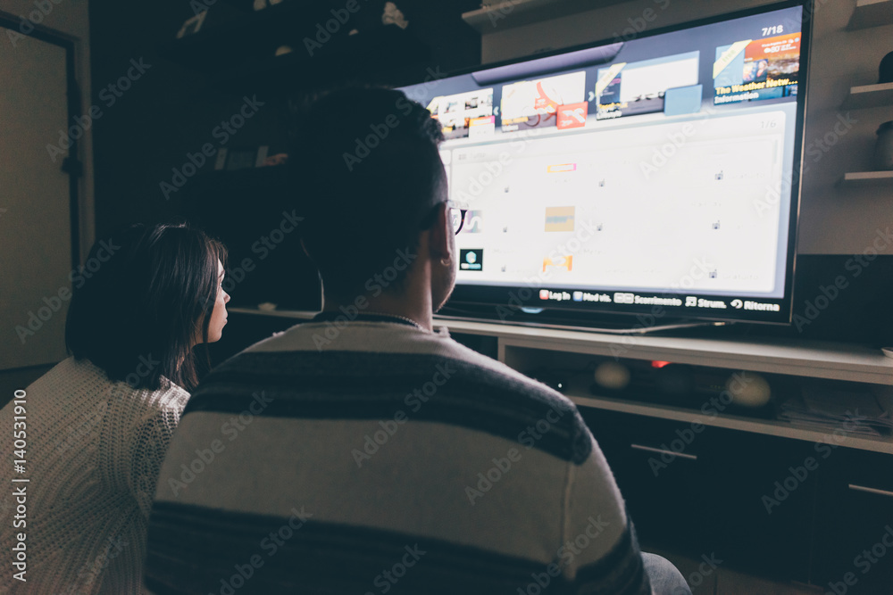 Back view of couple indoor watching tv - relaxing, Back view of couple indoor watching tv - relaxing,
