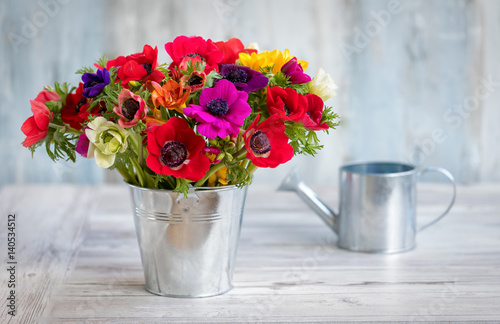 Fototapeta Naklejka Na Ścianę i Meble -  Bunte Frühlingsblumen im Zinktopf: Anemonen und Fresien