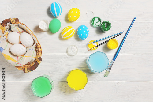 Close up of colorful Easter eggs in a basket. brush and paint