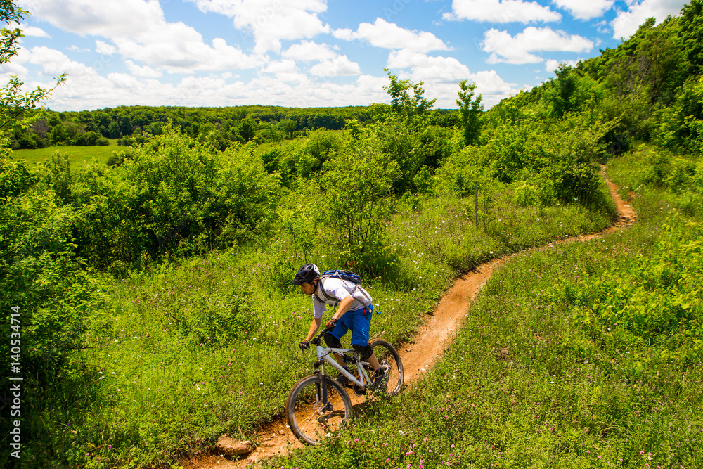 Man riding his mountain bike on a single track trail