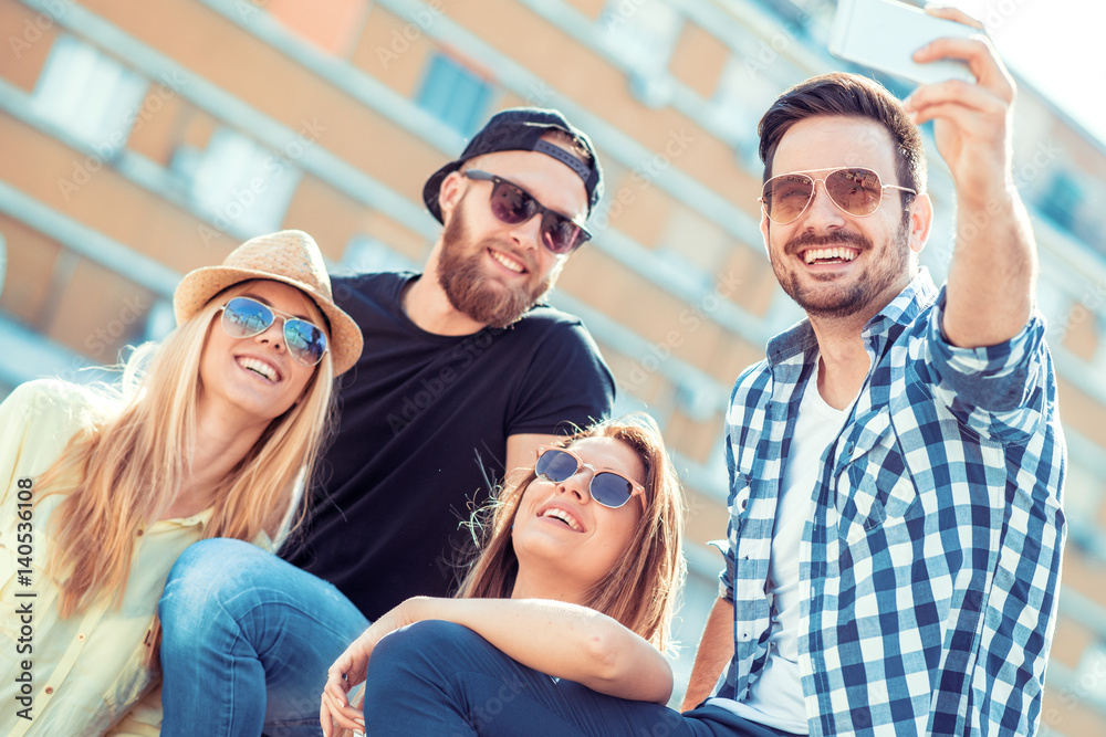 Group of four happy friends taking selfie Group of four happy friends taking selfie