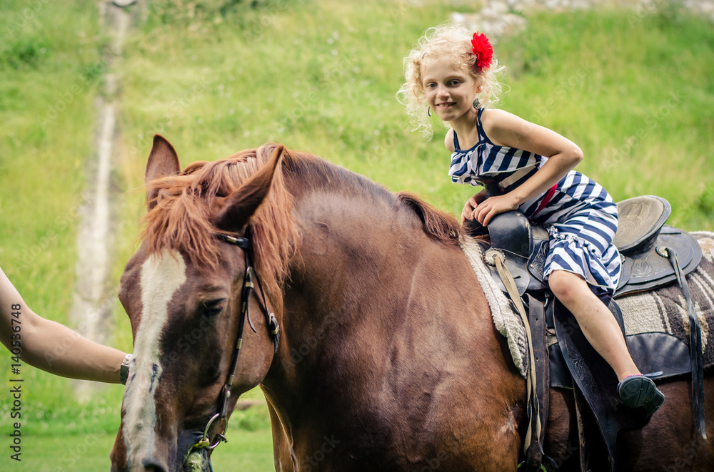 Fototapeta premium child riding a horse