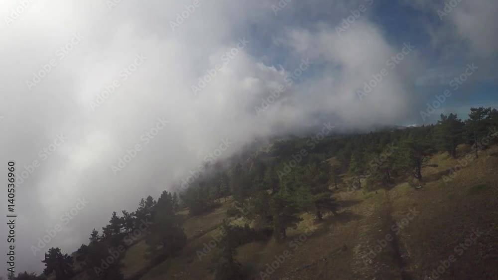 Time Lapse of clouds blowing over mountain Kokiya Kala (Kokiya-Kaya-Bash) near Aya Cape. Forest Crimea. Mountain bike. Riding Bicycling in mountain and fog. Time Lapse of clouds blowing over mountain Kokiya Kala (Kokiya-Kaya-Bash) near Aya Cape. Forest Crimea. Mountain bike. Riding Bicycling in mountain and fog.