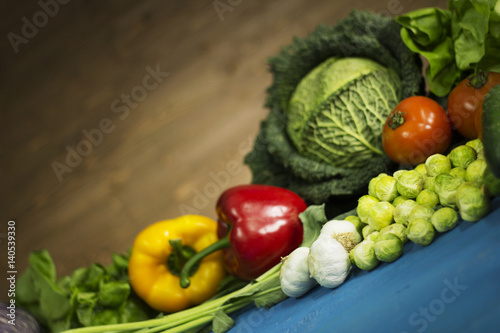 Young spring vegetables on  wood. Background layout with free text space.