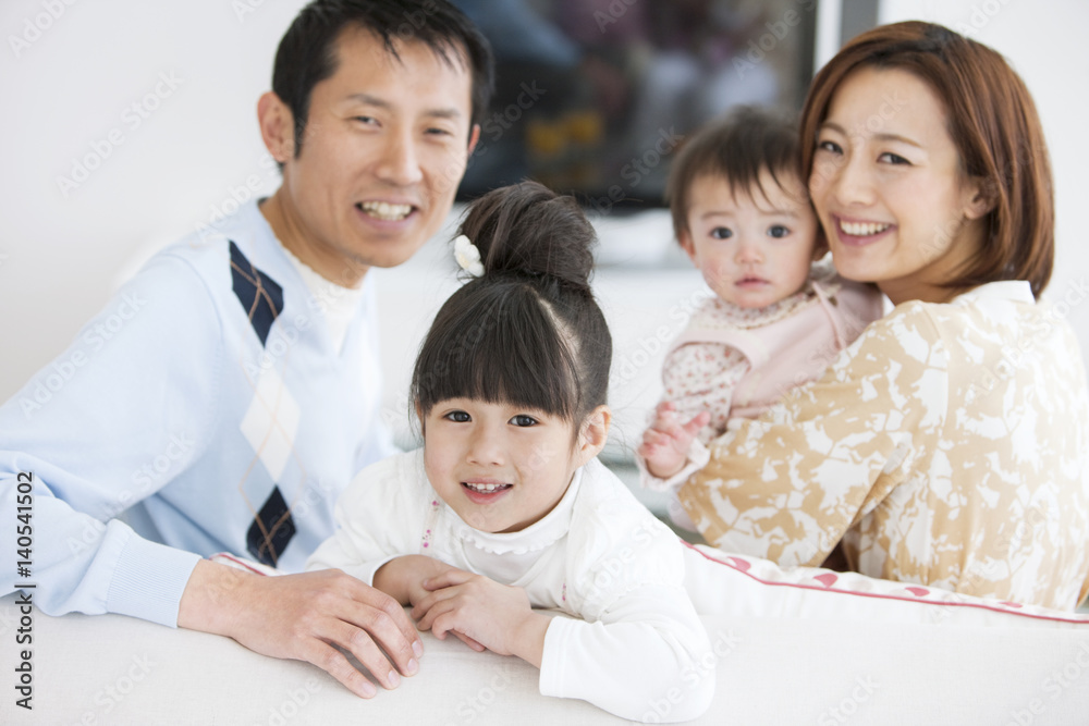 Portrait of family sitting on sofa Portrait of family sitting on sofa