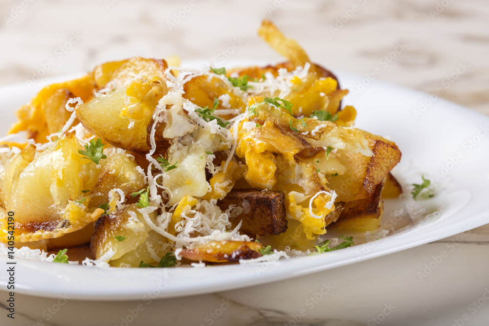 Fries with smashed eggs and parmesan with herbs