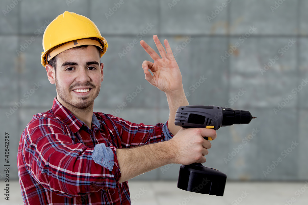 builder with the drill and the sign of approval, okay builder with the drill and the sign of approval, okay