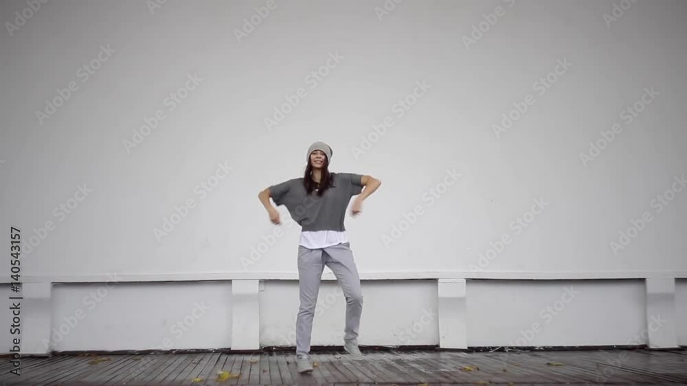 Young girl dances on the street scene. Young girl dances on the street scene.