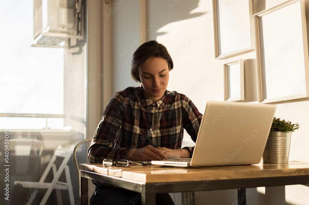 Entrepreneur or student working or studying and writing notes at home