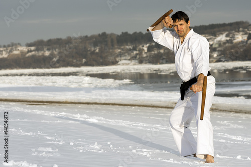 practicing martial arts with tonfa in the snow