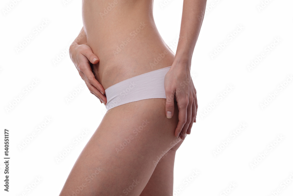 Slim woman body shape. Beautiful female wearing white underwear isolated. Healthy body, torso, slim waist, belly, abdomen close up. Sport, fitness, Dieting results.