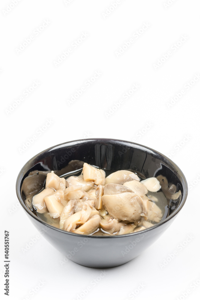 Sliced marinated mushrooms in the bowl isolated over white background Sliced marinated mushrooms in the bowl isolated over white background
