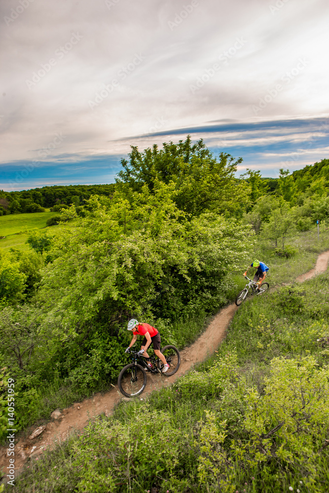 Couple Mountain Biking on Single Track in the Forest