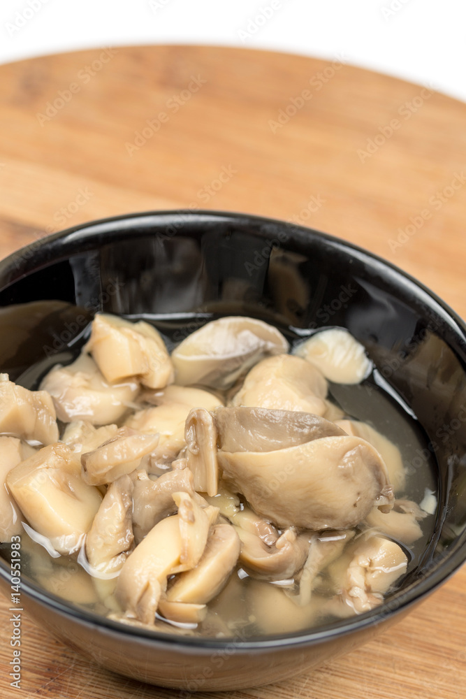 Sliced marinated mushrooms in the bowl isolated over white background Sliced marinated mushrooms in the bowl isolated over white background