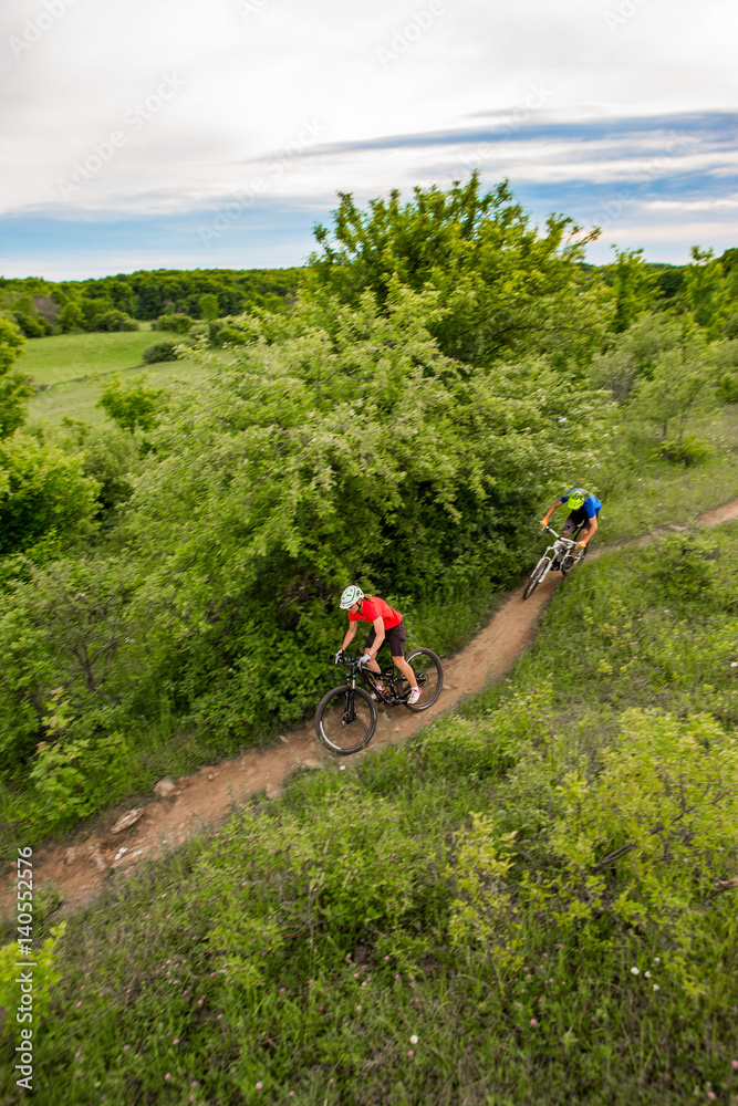 Couple Mountain Biking on Single Track in the Forest
