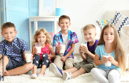 Cheerful children with glas...