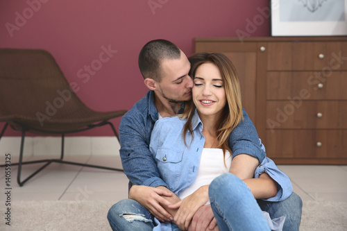Young couple sitting togeth...