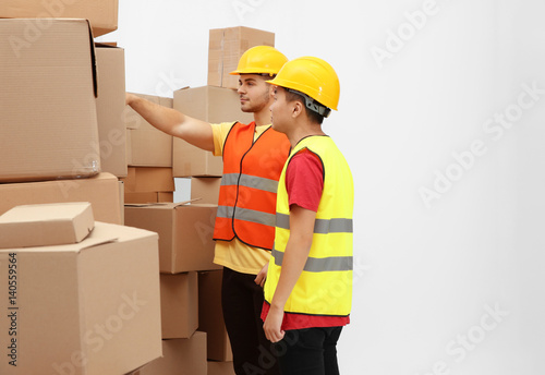 Workers near pile of cartoo...
