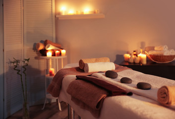 Foto auf Acrylglas Massagesalon Interior of modern massage room in candle light  © Africa Studio