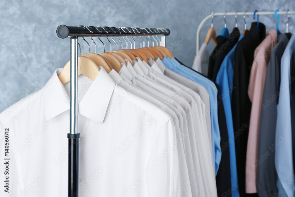 Rack of clean clothes hanging on hangers at dry-cleaning Stock Photo