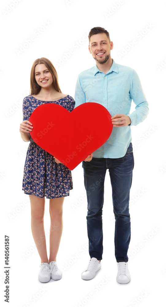 Happy young couple with red paper heart on white background Happy young couple with red paper heart on white background