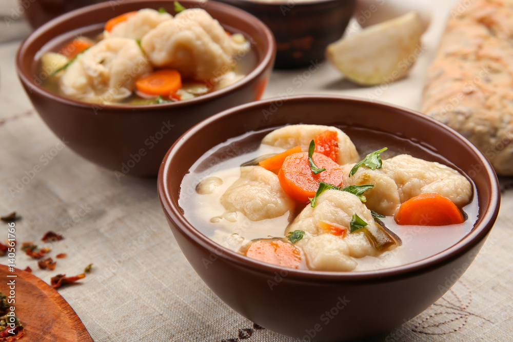 Portions of delicious chicken and dumplings on dining table Portions of delicious chicken and dumplings on dining table