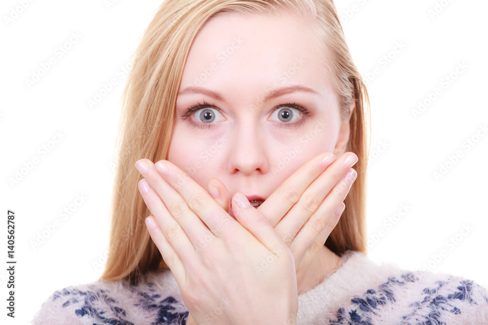 Shocked young woman covering mouth with hand Shocked young woman covering mouth with hand