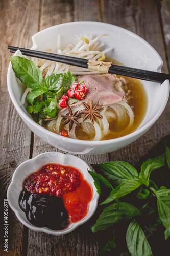 Pho Vietnamse Noodle Soup on Old Wood. Image for Food Advertise Concept