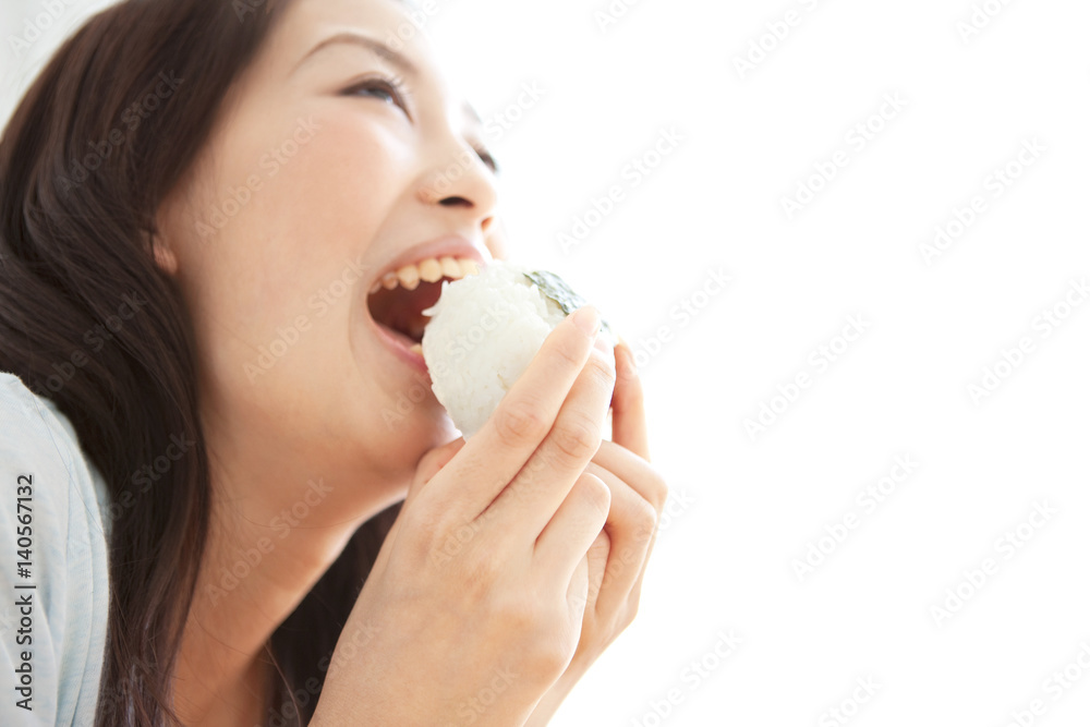 Young woman eating a rice ball Young woman eating a rice ball