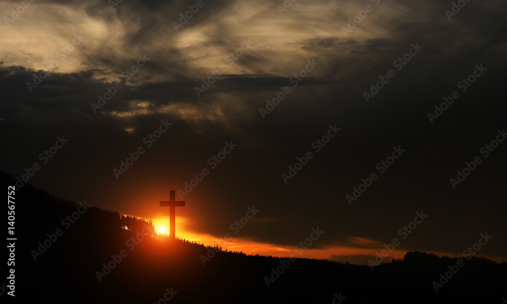 Cross at sunset on the hill