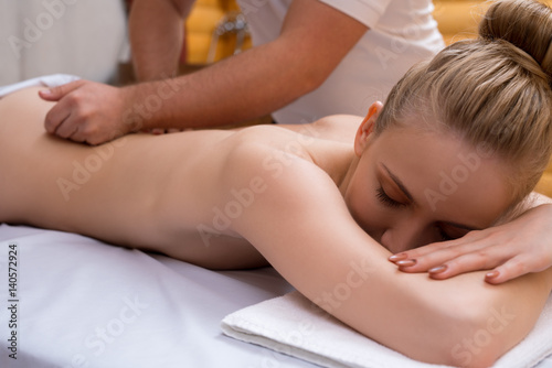 Young pretty woman enjoying massage procedure