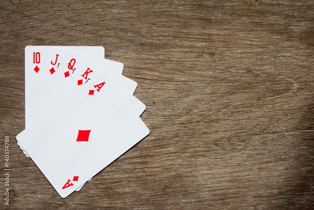 Five card of red diamond royal straight flush on wooden background