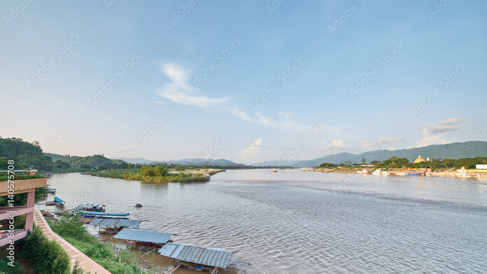 A wide angle view of Golden Triangle, Chiang Rai, Thailand, showing all 3 countries in a photo. On the left is Thailand, the land in the middle of the confluence is Myanmar while Laos is on the right.