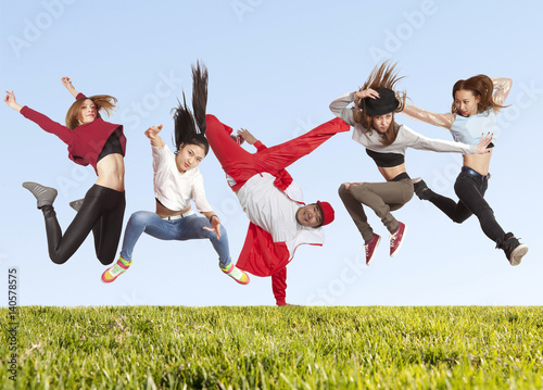 Many jumping happiness people on the grass