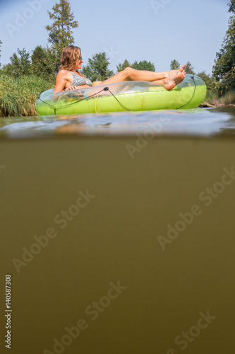 Couple tubing down the river in the summer