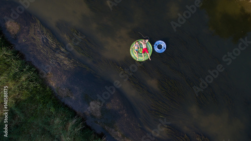 Aerial photo of a couple tubing down the river