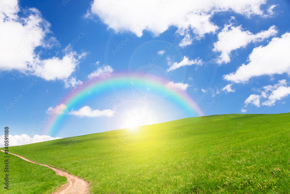 idyllic landscape of green heels, blue sky, rainbow and sun idyllic landscape of green heels, blue sky, rainbow and sun
