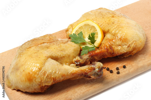 Grilled chicken with lemon on wood background