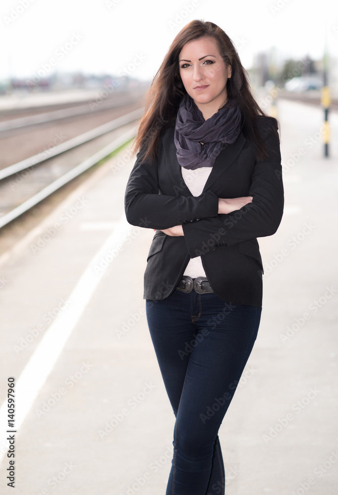 Beautiful woman standing at the train station Beautiful woman standing at the train station