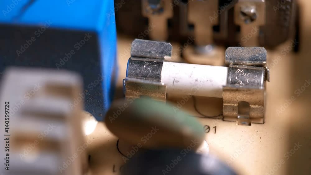 Man puts a fuse in the device Man puts a fuse in the device