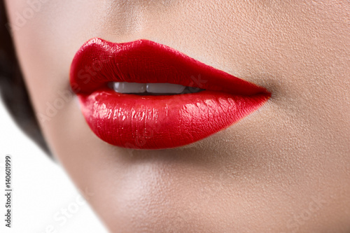 Close up shot of the lips of a woman wearing lipstick or lip glo