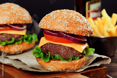 Cheeseburgers on wooden table with copy space