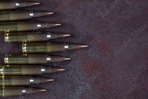 Group of ammunition on a rusted metal background 