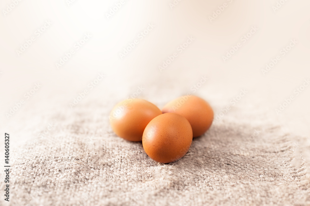 Eggs on wooden brown colored background closeup. Eggs on wooden brown colored background closeup.
