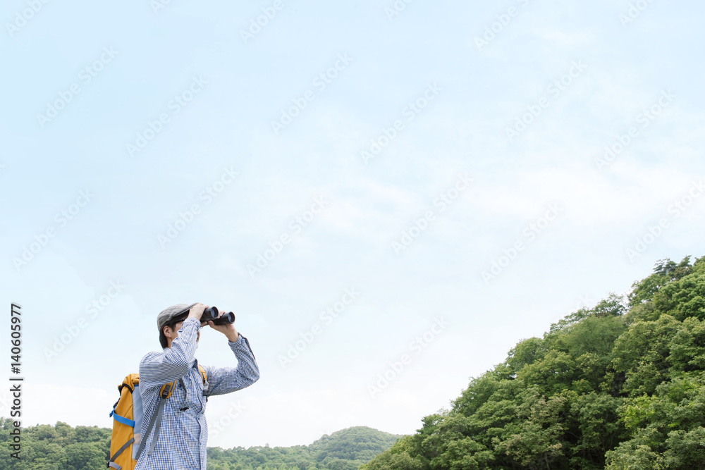 Man looking through binoculars Man looking through binoculars