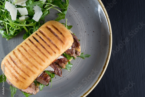 grilled steak medium fresh baked ciabatta sandwich beer